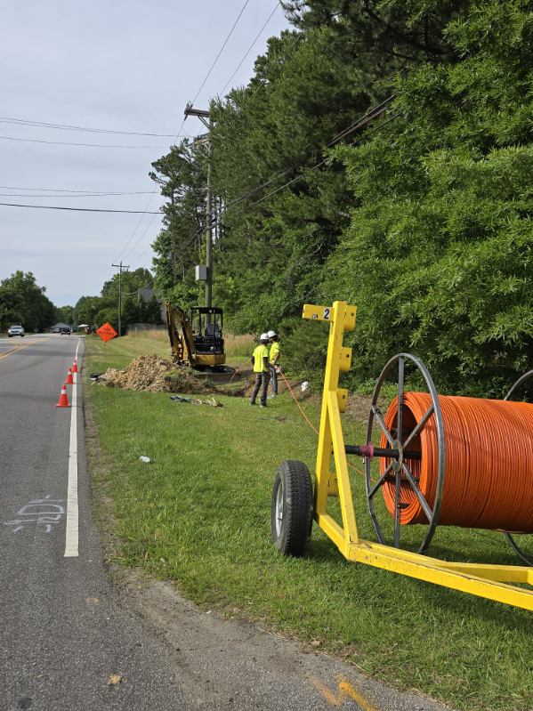 men working on the side of the road.